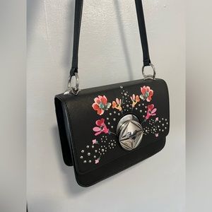 It is a Calvin Klein cross body bag in multi shade/black. It is new with tags.